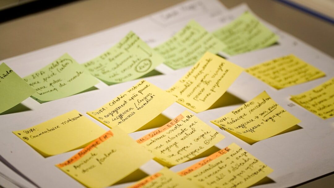 Diverse team brainstorming with sticky notes on a glass wall